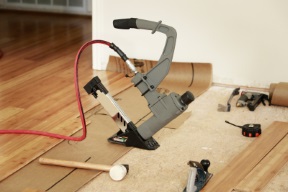 hardwood floor being installed with tools visible